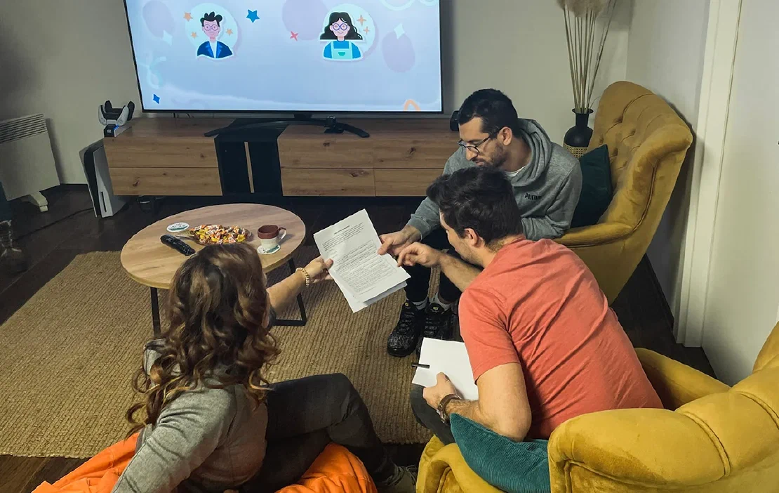 Alas employees collaborating in a homey office space.